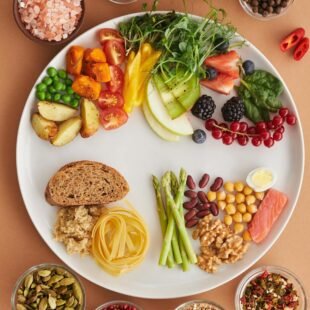 Assorted high-fiber foods including vegetables, fruits, nuts and grains
