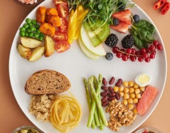 Assorted high-fiber foods including vegetables, fruits, nuts and grains