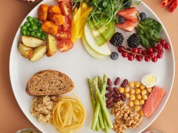 Assorted high-fiber foods including vegetables, fruits, nuts and grains