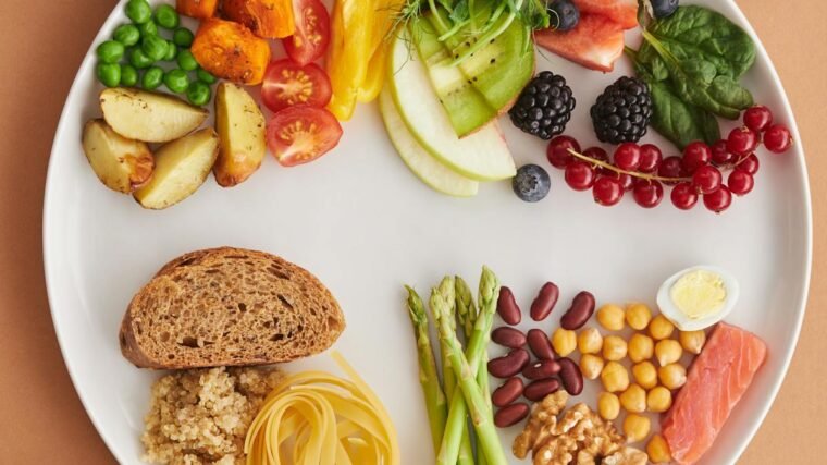 Assorted high-fiber foods including vegetables, fruits, nuts and grains