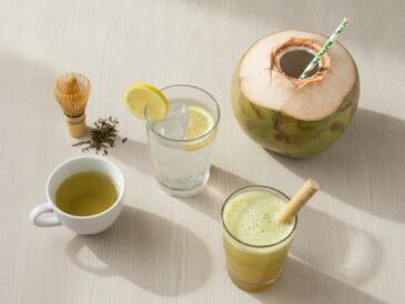 Glass of water, green tea, fresh coconut water and sugarcane juice on a wooden table